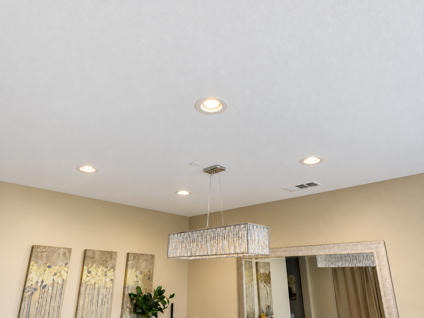 Retouched photograph of pendant and recessed lighting in a dining room